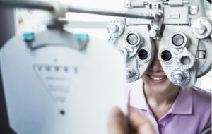 A woman at the optometrist getting her vision examined