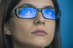 A woman wearing glasses with blue light protection coating