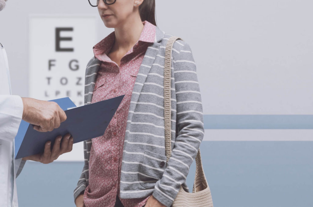 A patient and an optometrist talking at the optometry.