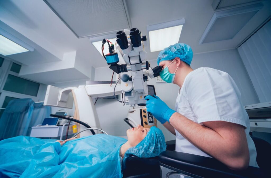 An eye doctor prepares to perform a laser eye surgery on their patient.