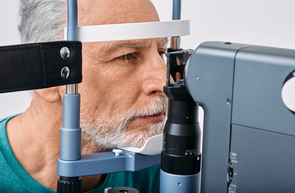 Older man receiving an eye exam with a slit lamp to check for glaucoma.