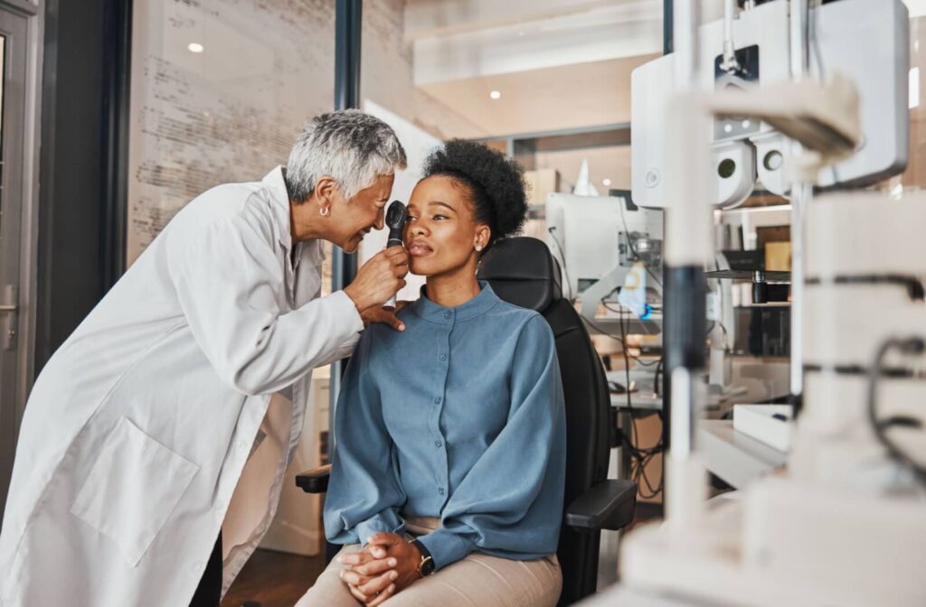 An optometrist evaluates a patient's retinal health with an ophthalmoscope during a routine eye exam.